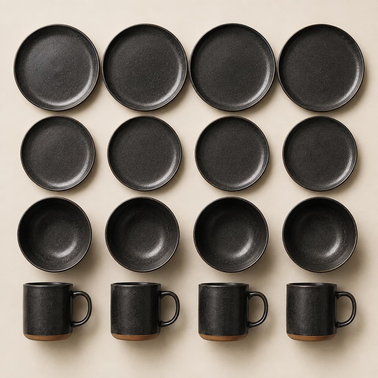 Four-Person Everyday Set — charcoal glazed stoneware with an unglazed clay foot ring.