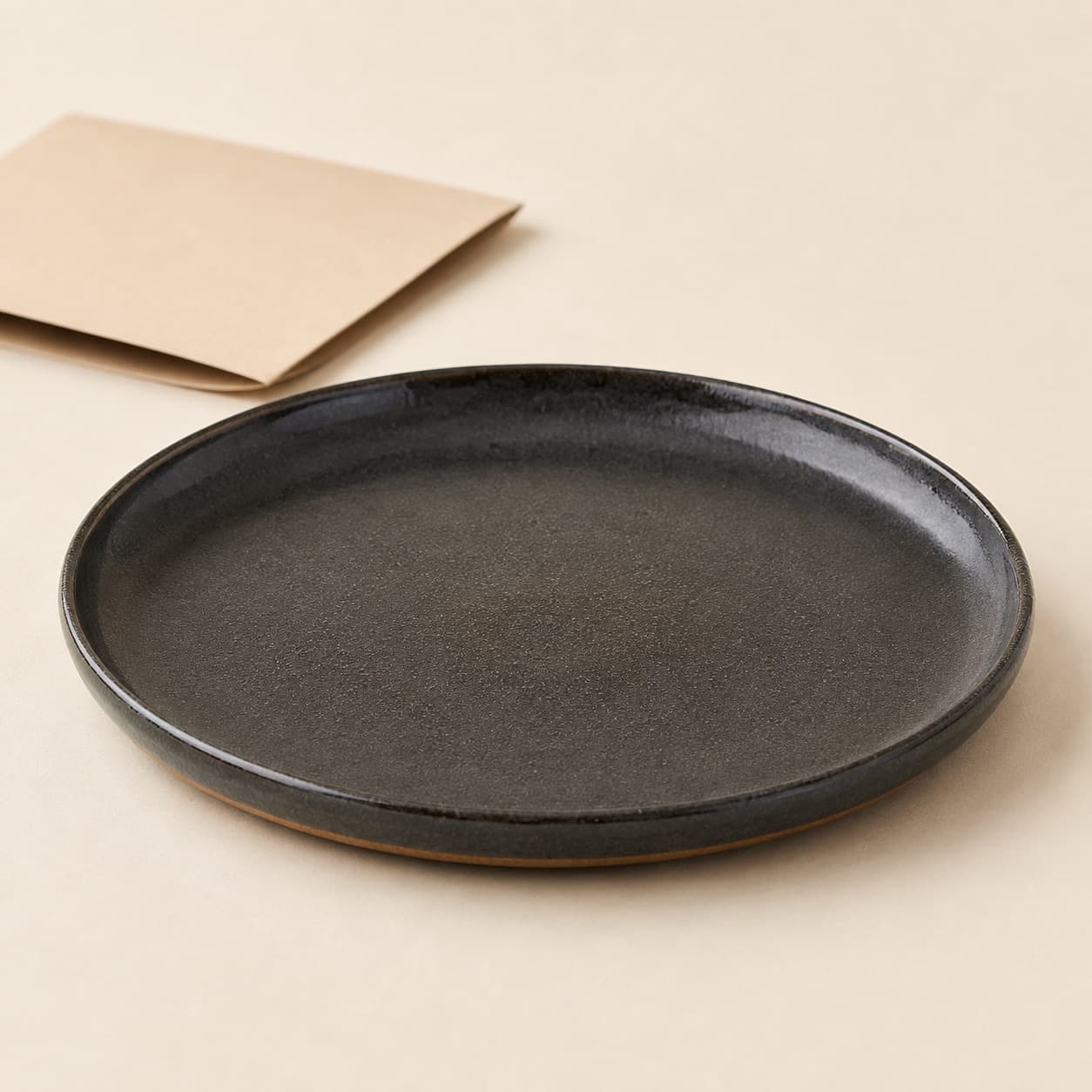 Replacement Dinner Plate Ø26 — charcoal glazed stoneware with an unglazed clay foot ring.